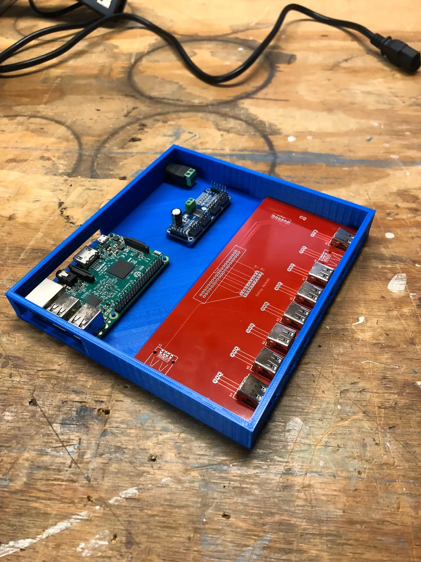 Controller electronics and printed enclosure parts laid out together