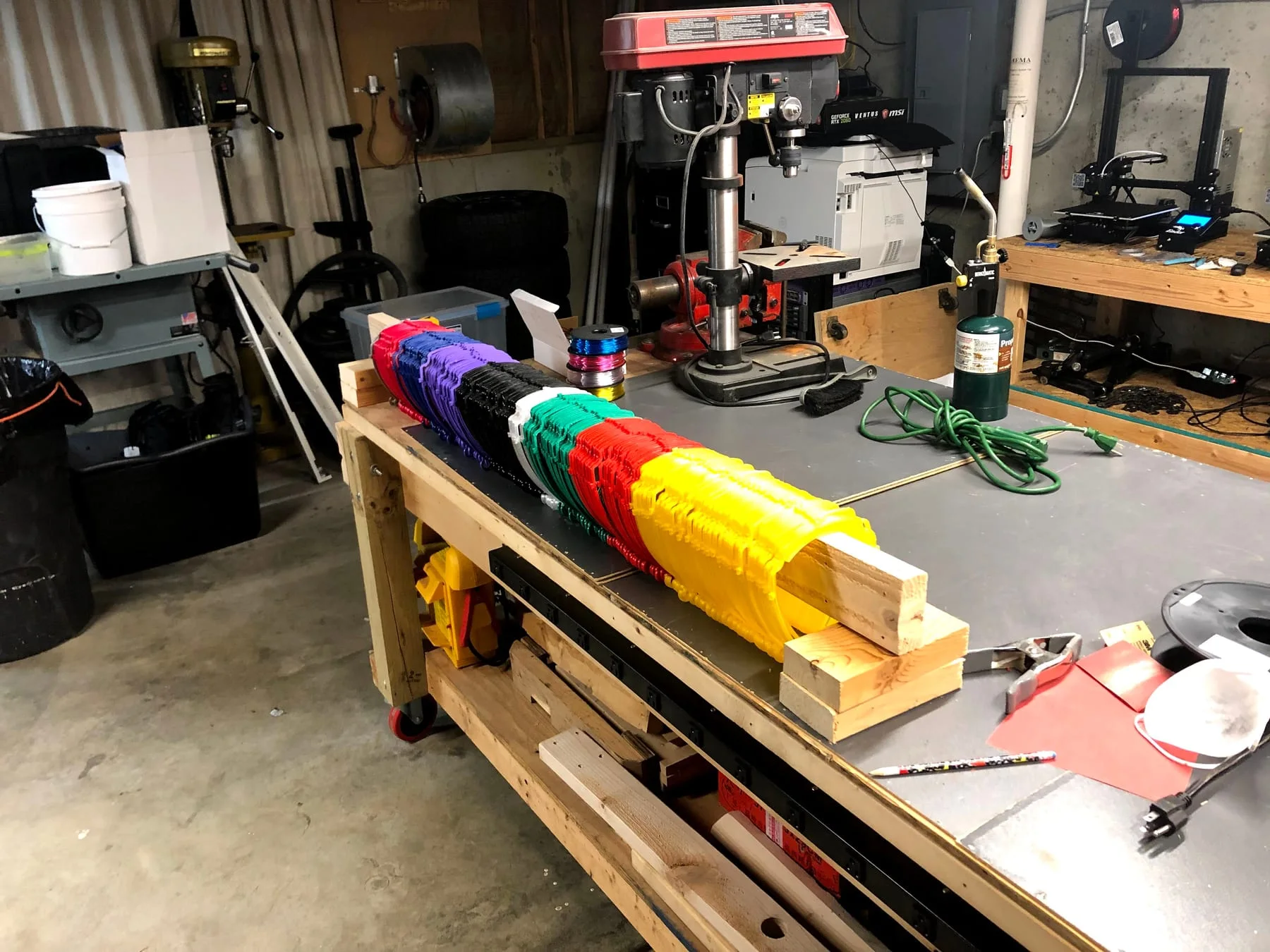 Multiple face-shield frames organized on a workshop rack